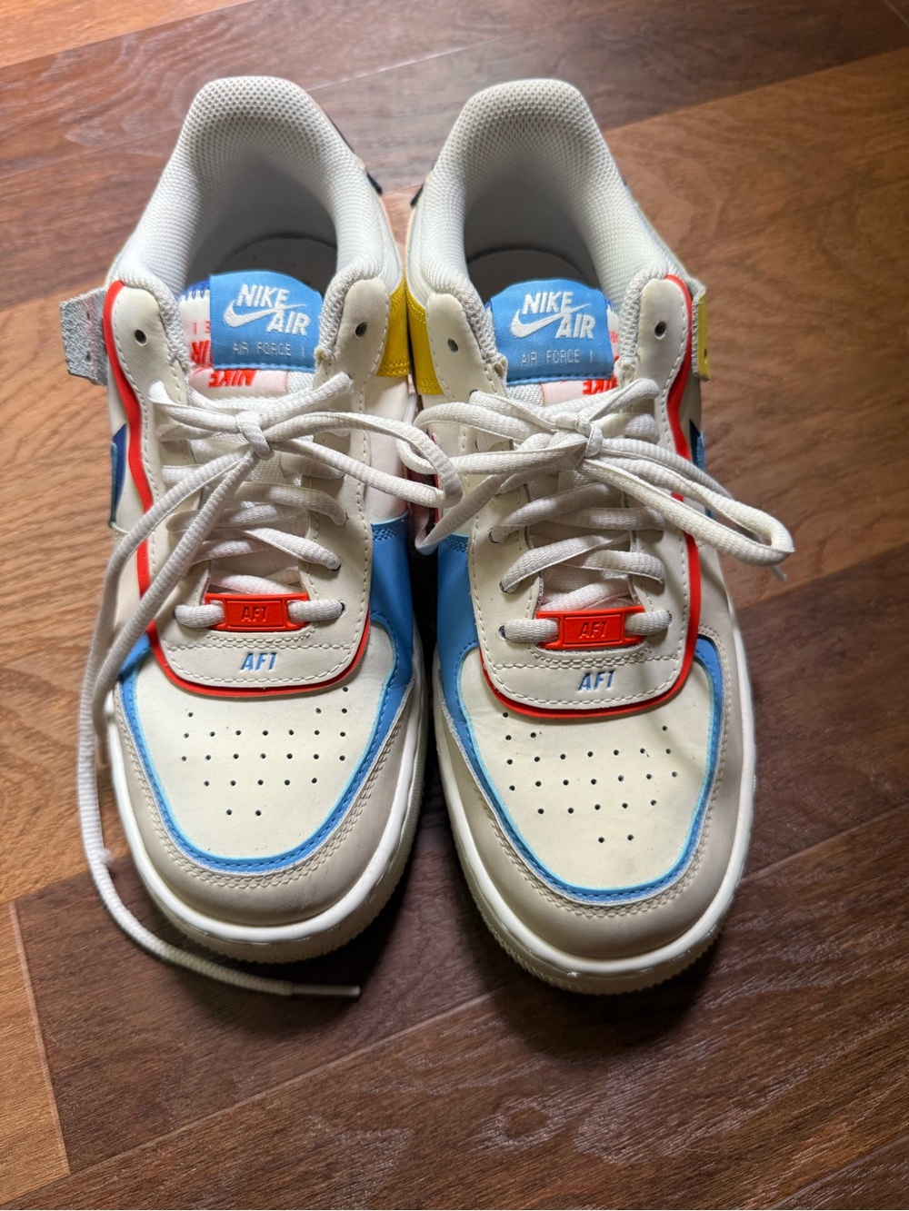 Nike Kids Sneakers in White with Blue, Red & Yellow Accents